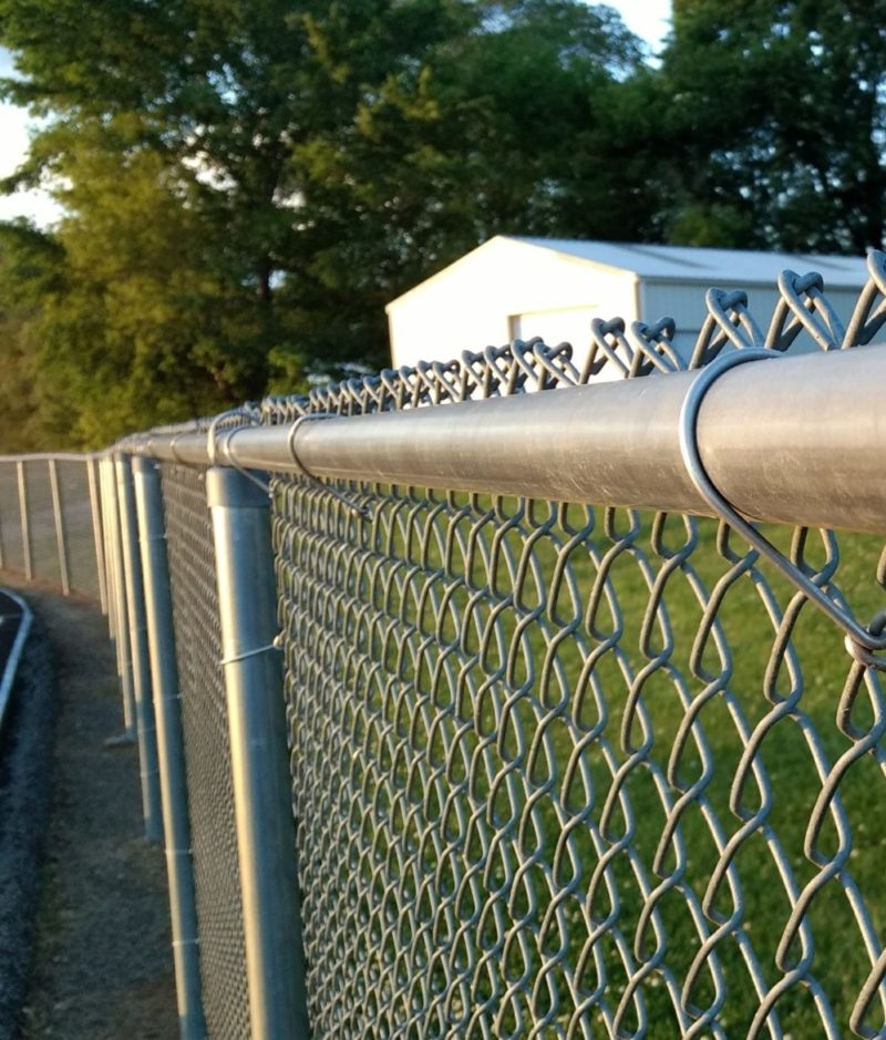 An old chain link fence gets ready for demolition by the Wilco Junk Removal team